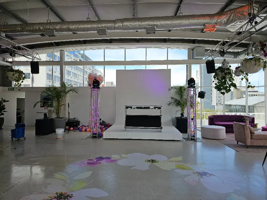 Indoor event audio and lighting setup with dance floor
